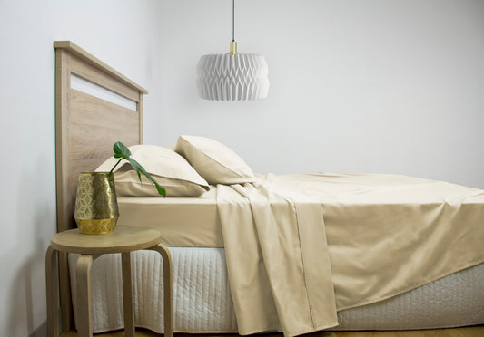 King cotton-rich sheet set with fitted sheet and pillowcases in light beige on bed