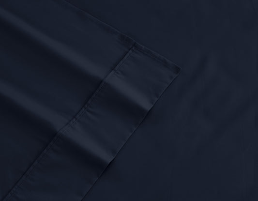 Dark navy fitted sheet corner with stitched edge detail