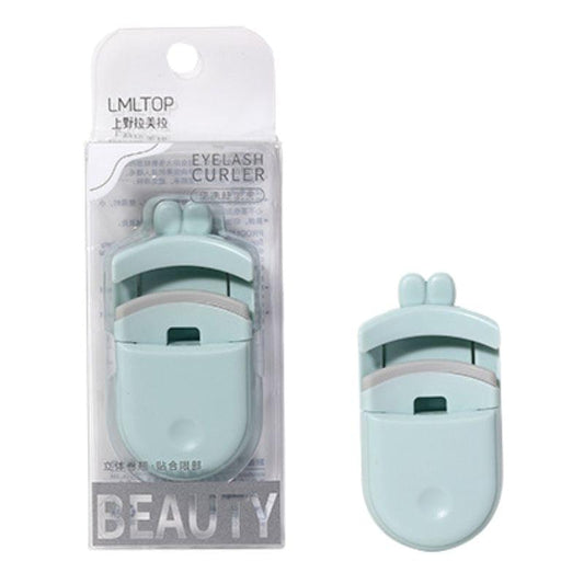 Mini eyelash curler in mint and white with hinged clamp, packaged in retail box