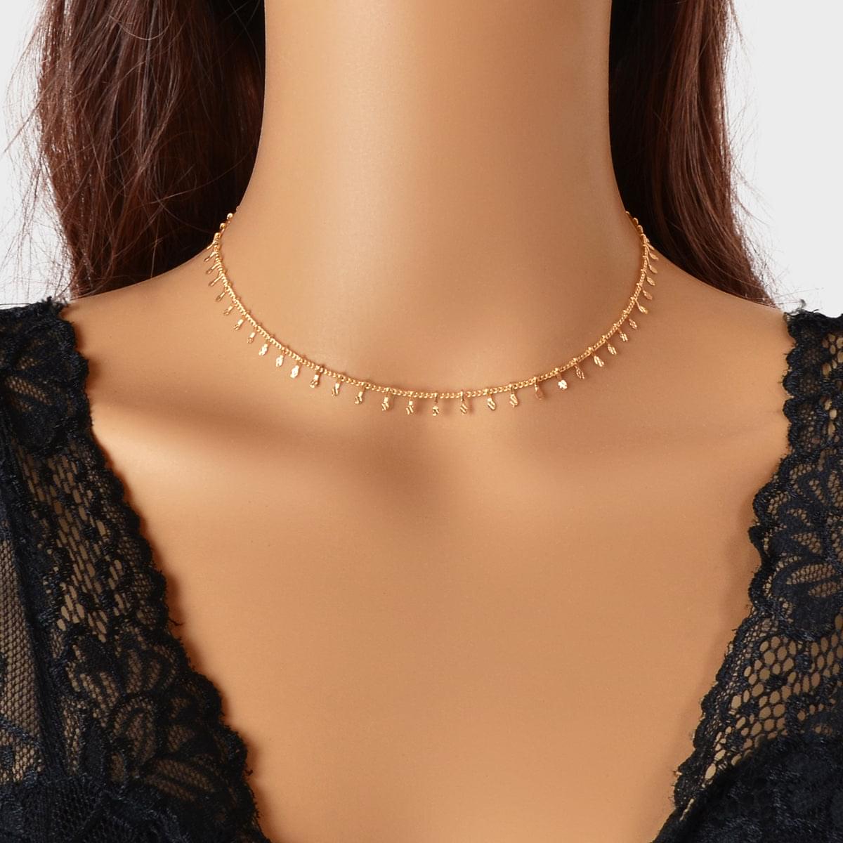 Gold-tone thin choker necklace with small dangling charms across the neckline.