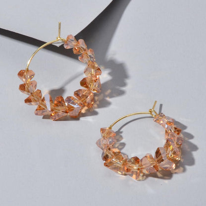 Gold-tone hoop dangle earrings with amber transparent acrylic bead chain