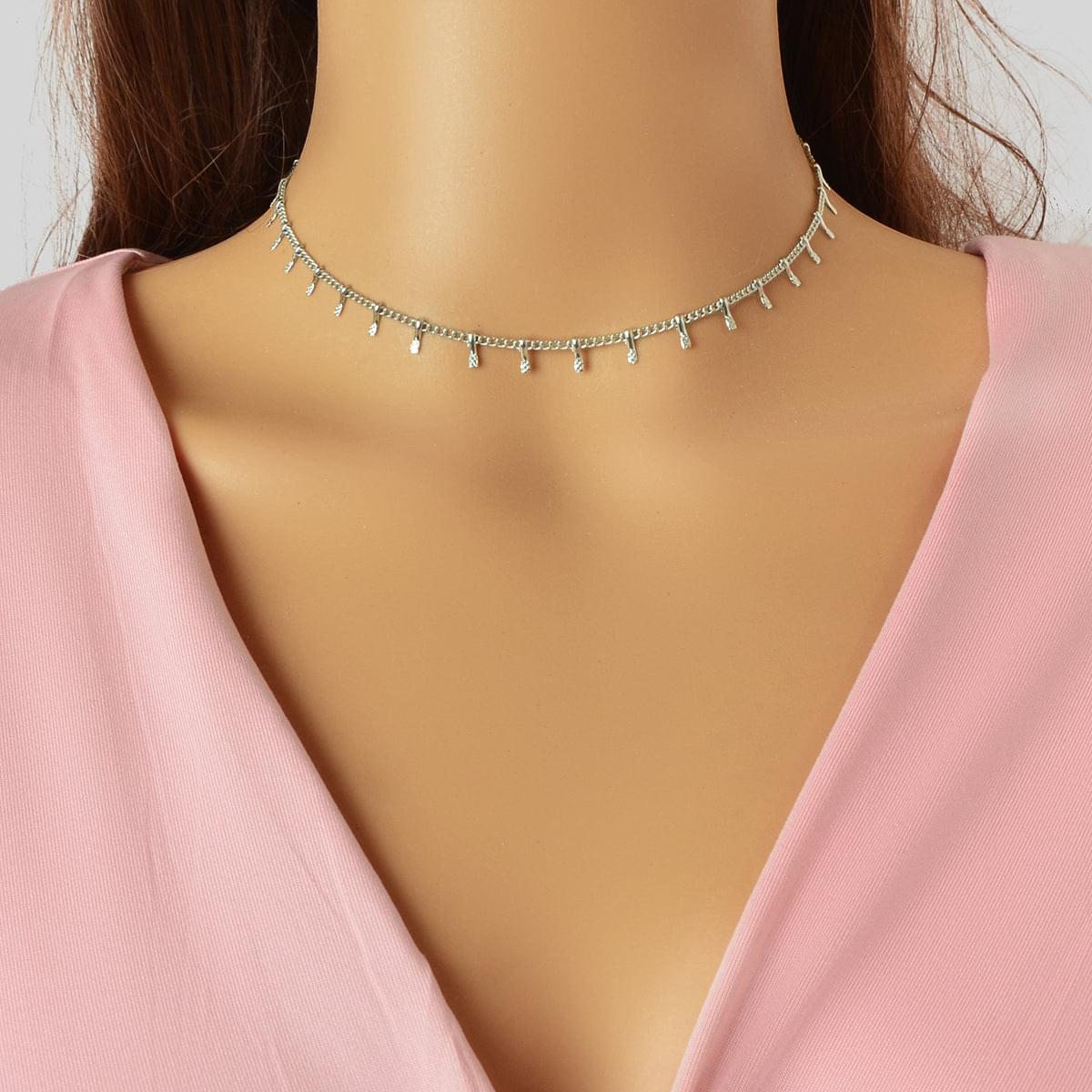 Silver-tone thin choker necklace with small dangling charms across the neckline.