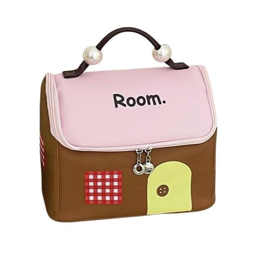 Cosmetic makeup bag with pearl handles, flap top, pink front panel with “Room.”