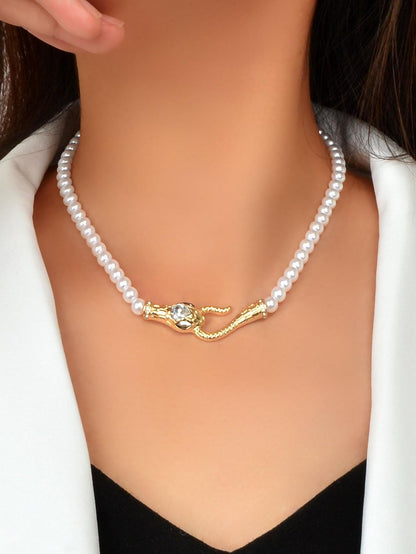 Short pearl bead choker necklace with gold-toned snake clasp and small rhinestone accents