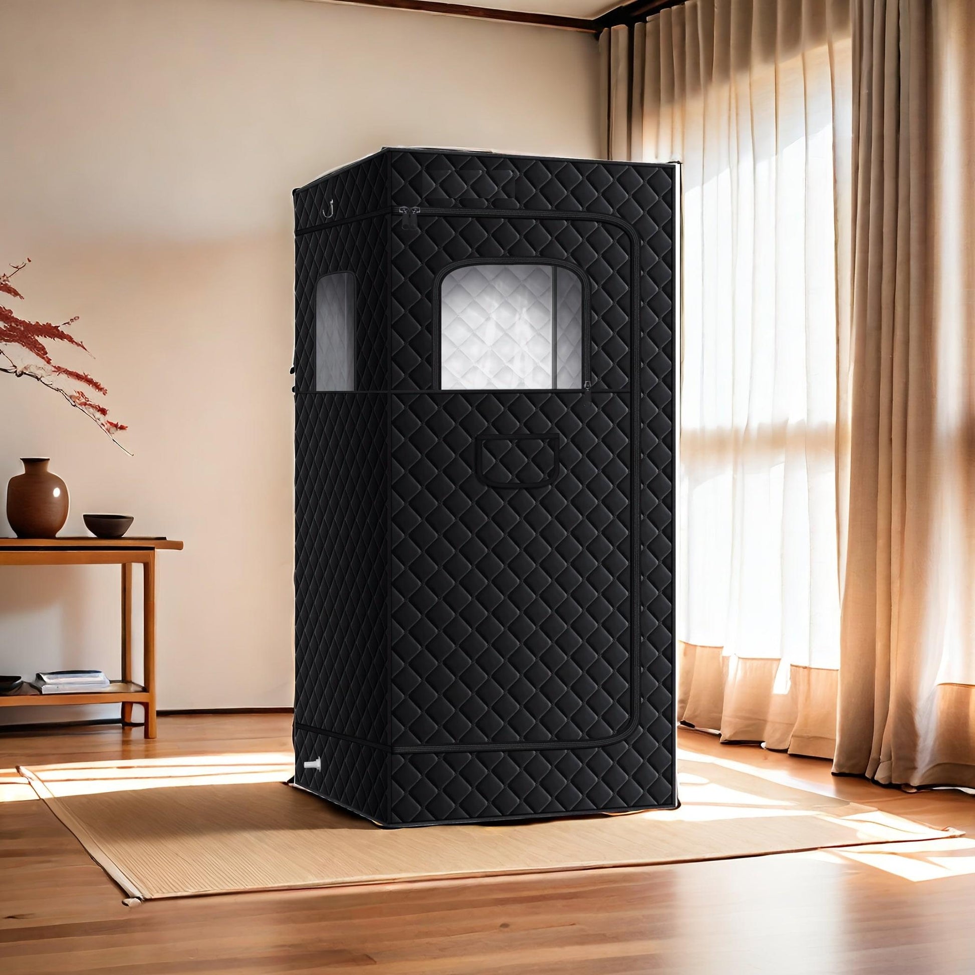 Black quilted sauna tent with arched front window and rectangular side vent panel