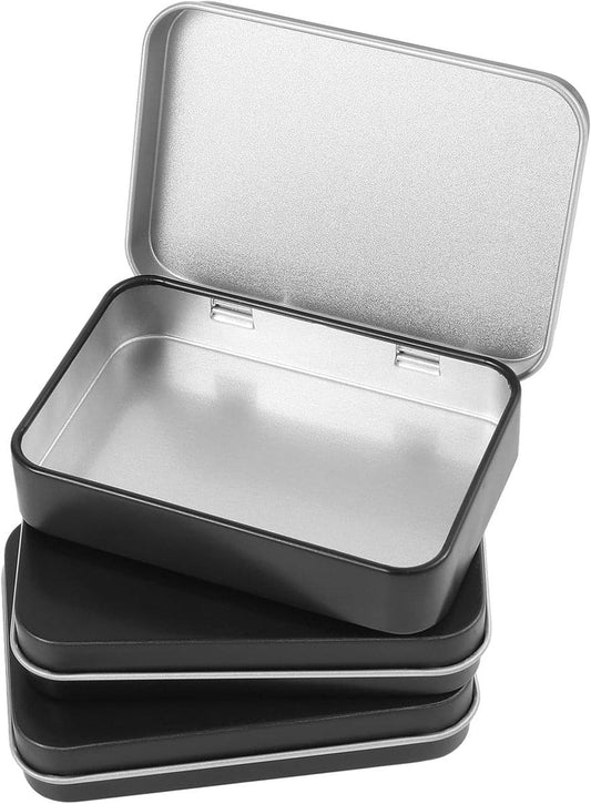 Set of 3 small black metal hinged storage boxes with flat lids for jewelry and crafts.