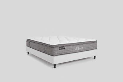 White-top mattress on a light base, gray sides with tufted padding and legs