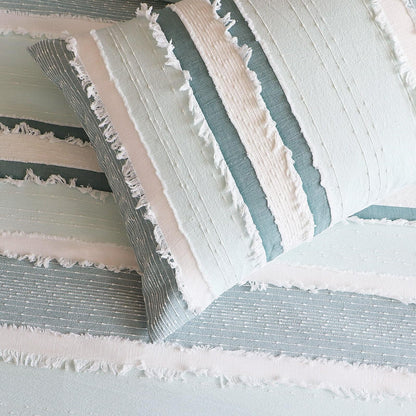 Striped quilt cover detail with light blue bands and white ruffled edging
