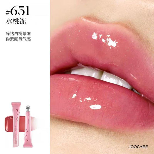 Soft pink lip gloss swatch on lips, glossy clear shine finish