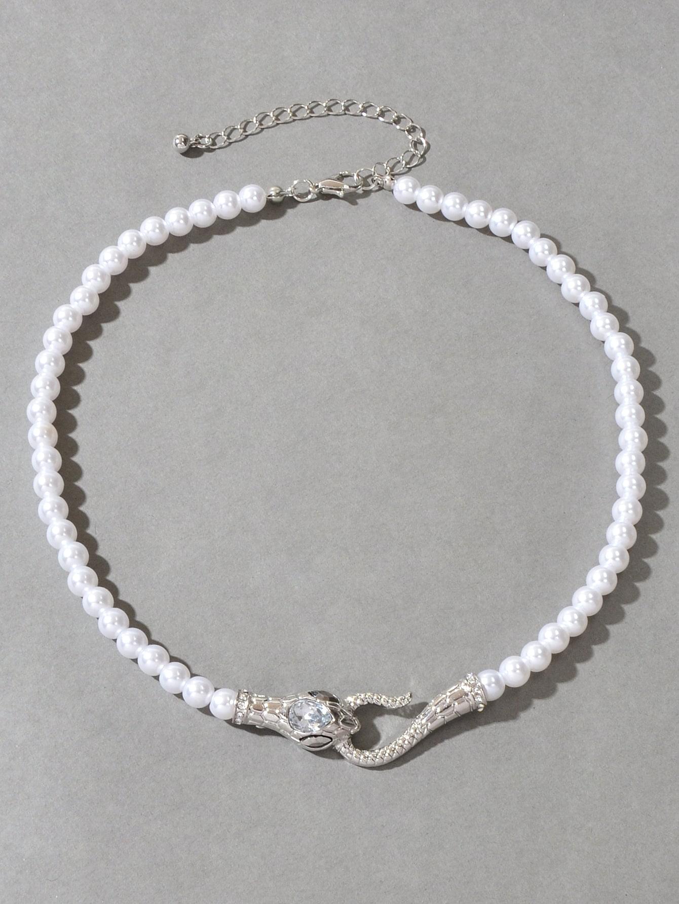Pearl bead necklace with silver-toned chain and rhinestone snake detail at the clasp