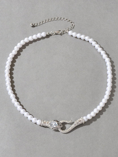 Pearl bead necklace with silver-toned chain and rhinestone snake detail at the clasp