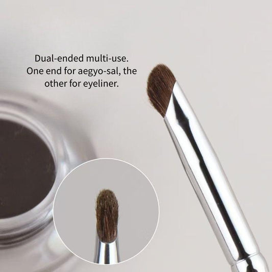 Precision makeup brush tip with brown bristles on a silver ferrule, angled head