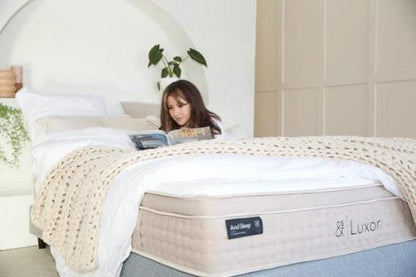 White quilted mattress with & Luxor label on the side, read-and-rest scene