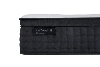 Black mattress with quilted side texture and label, white top edge visible