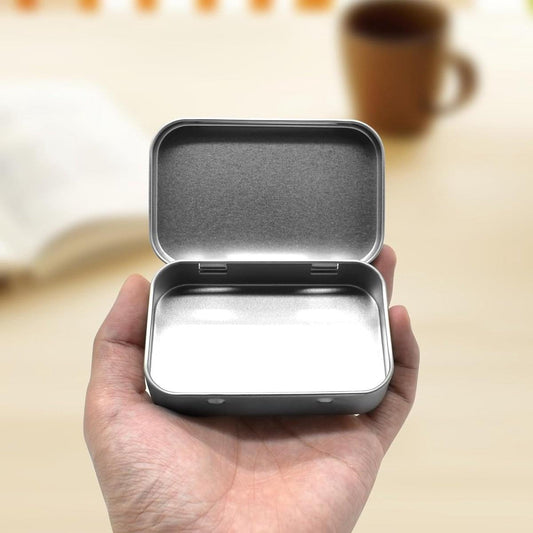 Silver metal storage tin with hinged lid, open to show empty interior