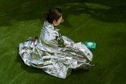Silver emergency blanket spread on the ground