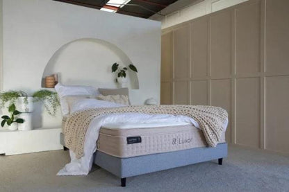 White quilted Luxor mattress on dark base, & Luxor side logo visible