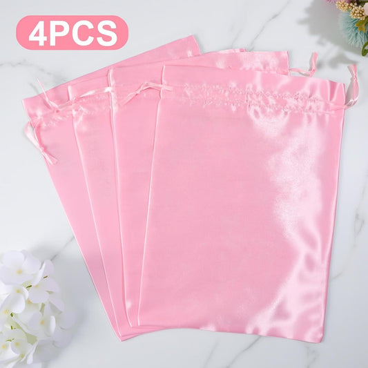 Set of four satin drawstring wig bags in pink fabric storage pouches
