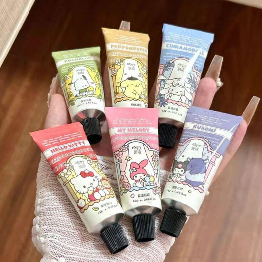 Set of six character hand creams with black caps, held in a hand