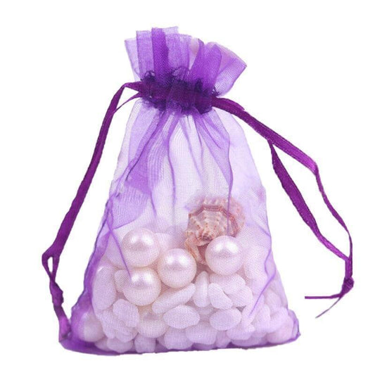 Dark purple organza drawstring bag filled with white beads or candies