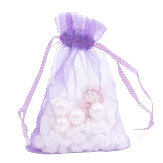 Purple sheer organza drawstring bag with ribbon top, filled with small white beads