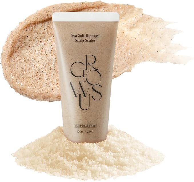 Sea salt scalp scrub tube standing over beige sea salt granules