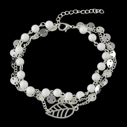 Silver-tone multi-layer anklet with white beads and leaf charm, short chain extender