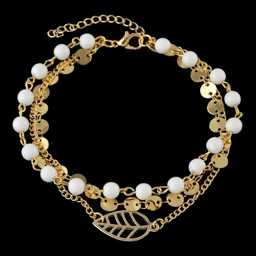 Gold-tone ankle bracelet with white bead drops and leaf charm on double chain layers