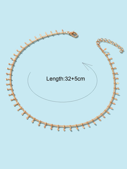 Gold-tone thin chain choker with mini dangling charms and small side clasp at top.
