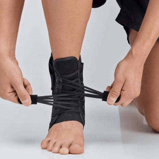 Black ankle brace worn on foot, laced closure with hook-and-loop strap