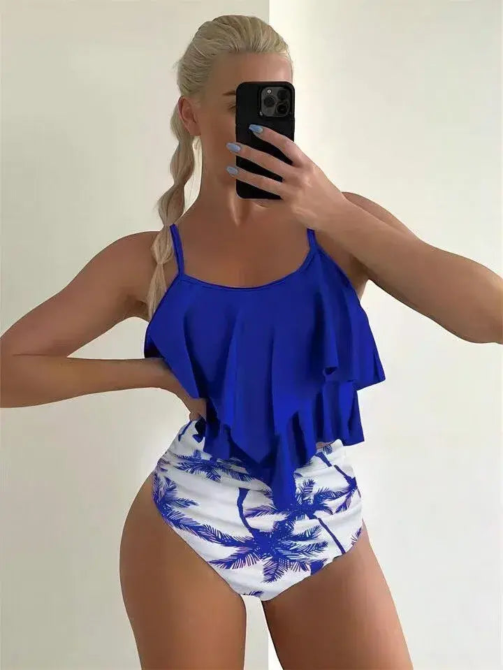 Two-piece ruffle tankini swimsuit with royal blue ruffled top and white palm print high-waist