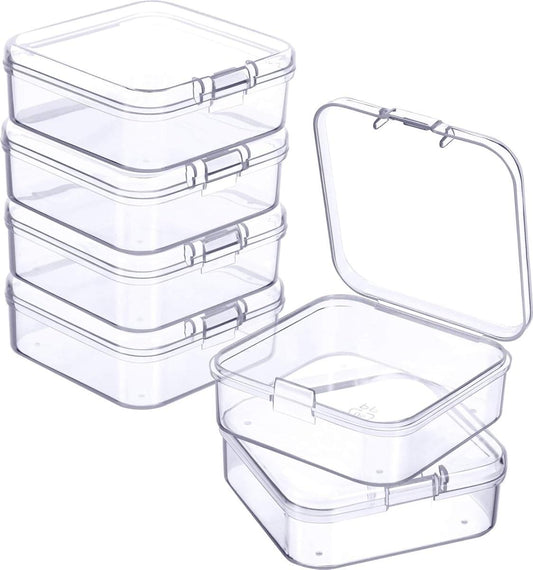 Stackable clear plastic mini storage boxes with hinged lids, one open for access