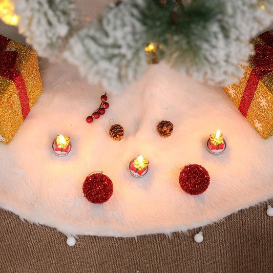 White faux fur tree skirt with decorated center and small pom trim on edge