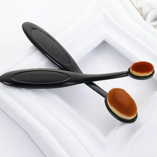 Set of flat foundation brushes with oval heads and brown bristles on black handles