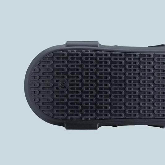 Black rocker sole outsole with textured circular grip pattern.