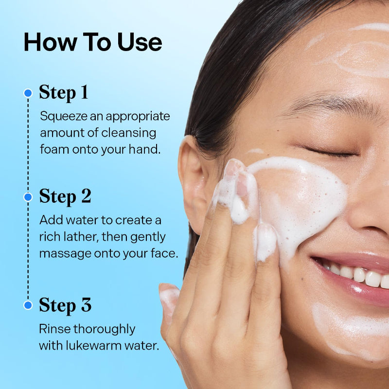 Cleansing foam lather being applied on cheek, with hands rubbing gently