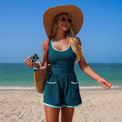 Teal sleeveless V-neck swimsuit with white trim, gathered waist, and side pockets