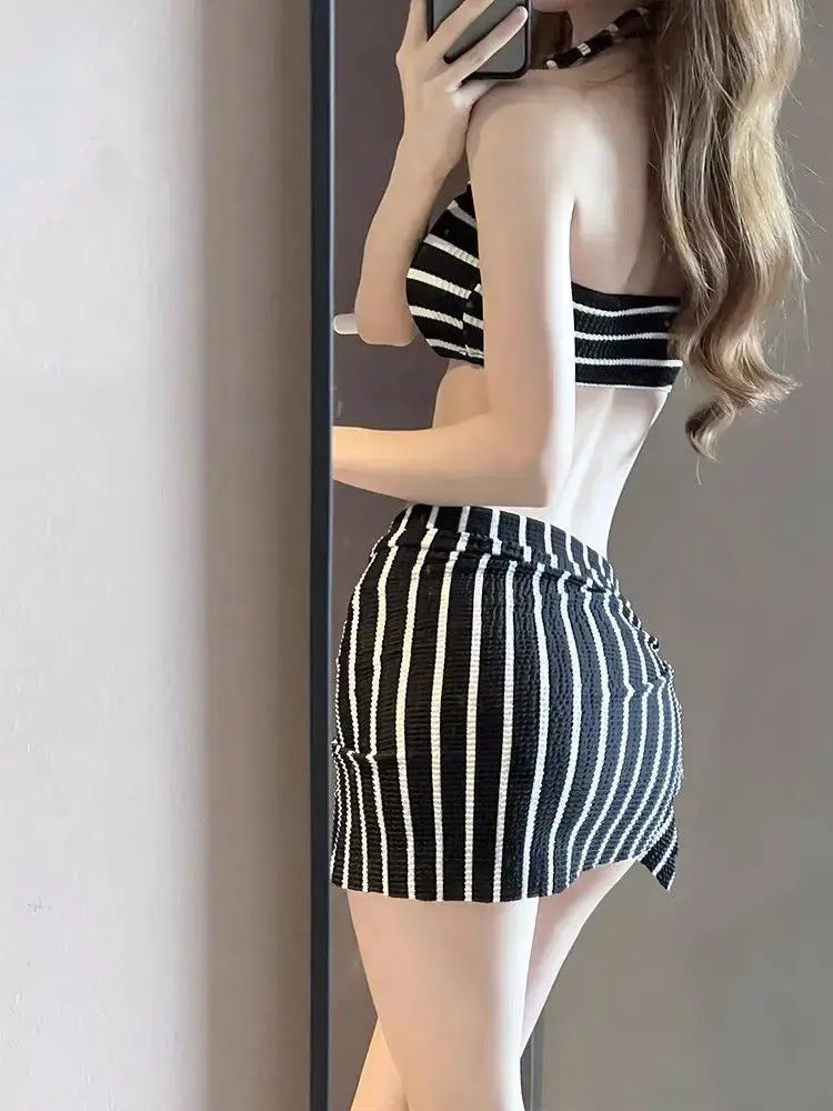 Women's black-and-white striped bikini bottom with gathered side drape and ruching