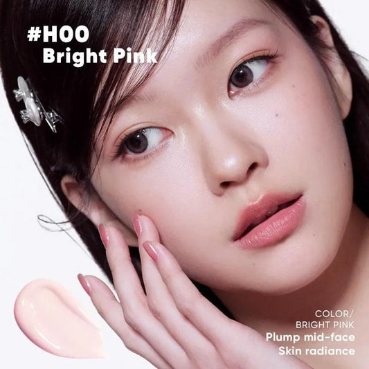 Model wearing bright pink pearly highlighting concealer on cheeks and under-eye
