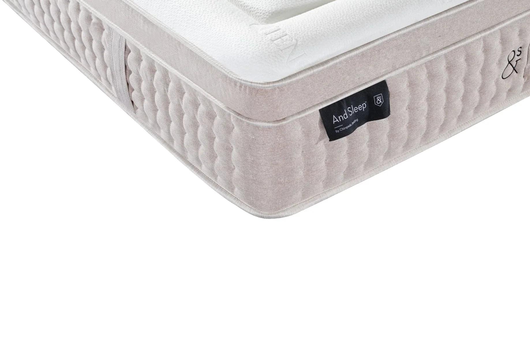 Quilted white mattress top with gray fabric sides and AndSleep label