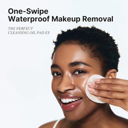 Person wiping makeup with a white cleansing oil pad on the face
