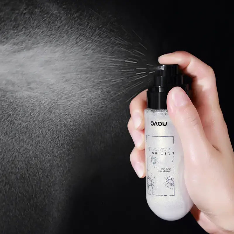 Clear facial mist spray bottle with black nozzle, held in a hand