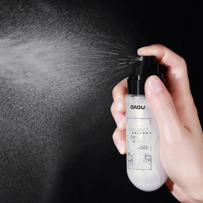 Clear facial mist spray bottle with black nozzle, held in a hand