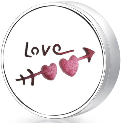 Round wearable diffuser locket with pink heart shapes and Love motif on felt insert