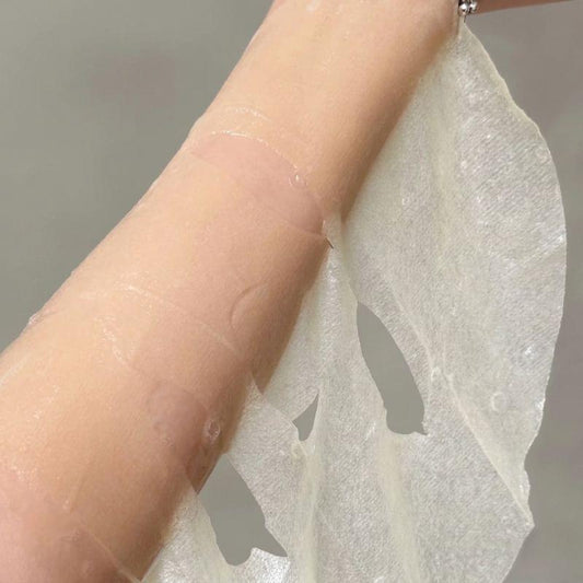 Silver facial mask sheet pouch held in hand