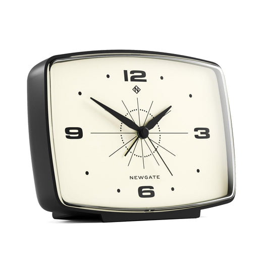 Black alarm clock at angle with cream dial and starburst-style hands