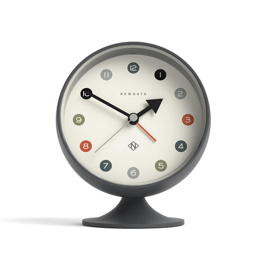 Grey alarm clock face with black hands, red seconds hand, and black base