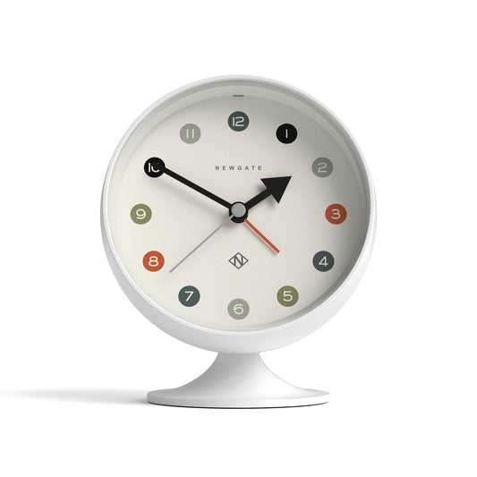 White spheric alarm clock with circular dial, Newgate logo, red seconds hand, and tabletop stand