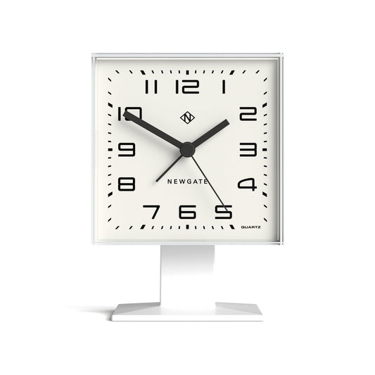 White square alarm clock with black hands and hour markers on a desktop stand