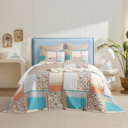Quilted reversible coverlet with patchwork floral squares in teal and cream
